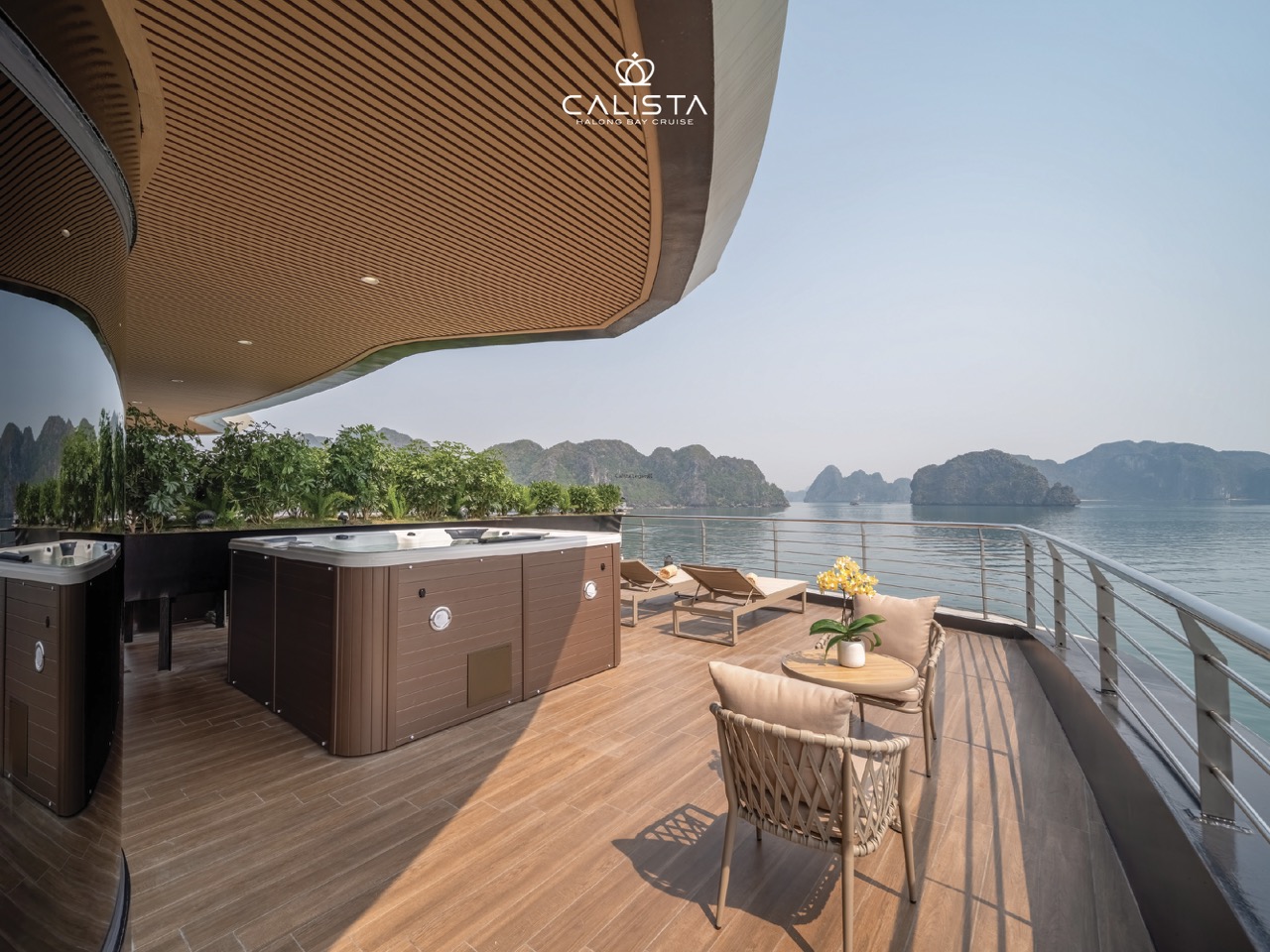 Stunning view from a luxury cruise balcony overlooking Halong Bay's emerald waters and limestone isl.