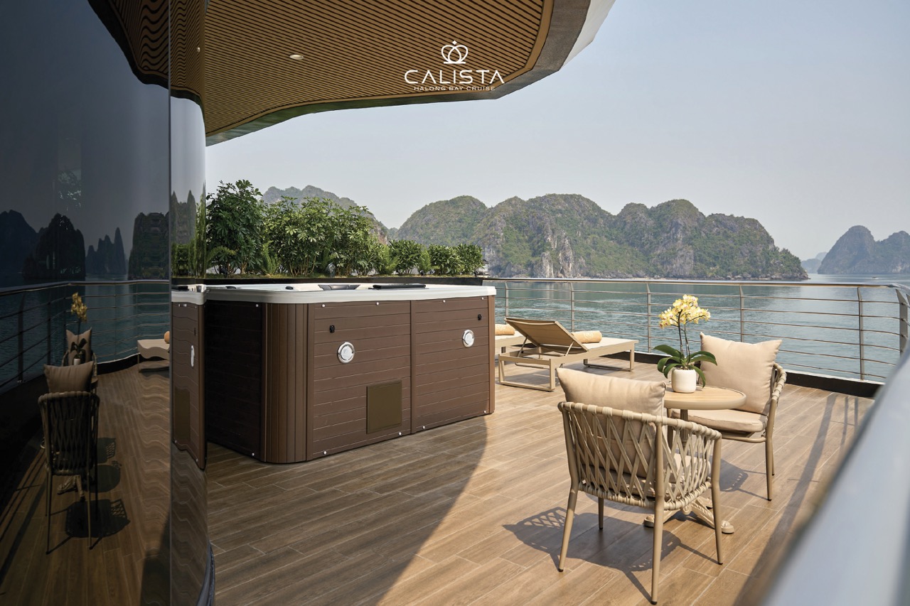 Stunning view from the Calista Cruise balcony overlooking Halong Bay's emerald waters and limestone.