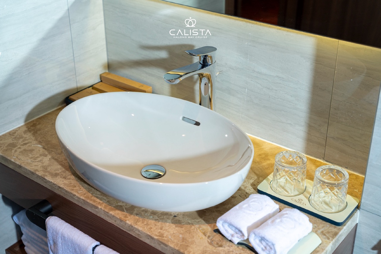 Luxurious cruise bathroom with modern sink and elegant decor in Halong Bay. Perfect for a relaxing a.
