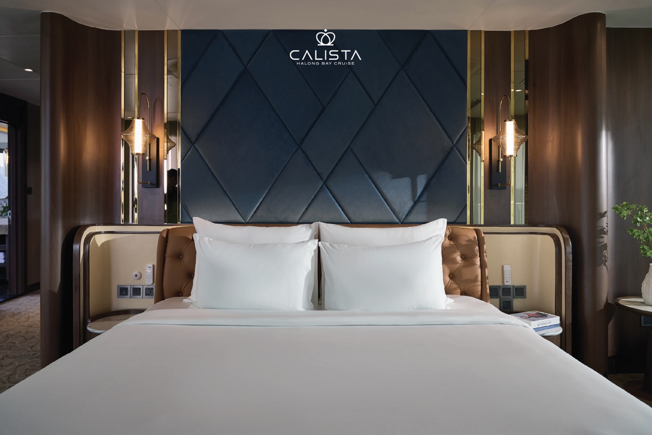 A cozy, elegant cruise balcony with modern decor overlooking Halong Bay's stunning waters.