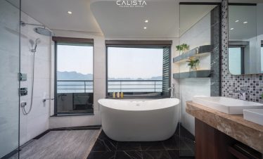 Luxurious cruise bathroom overlooking Halong Bay, perfect for relaxing and enjoying stunning seascap.