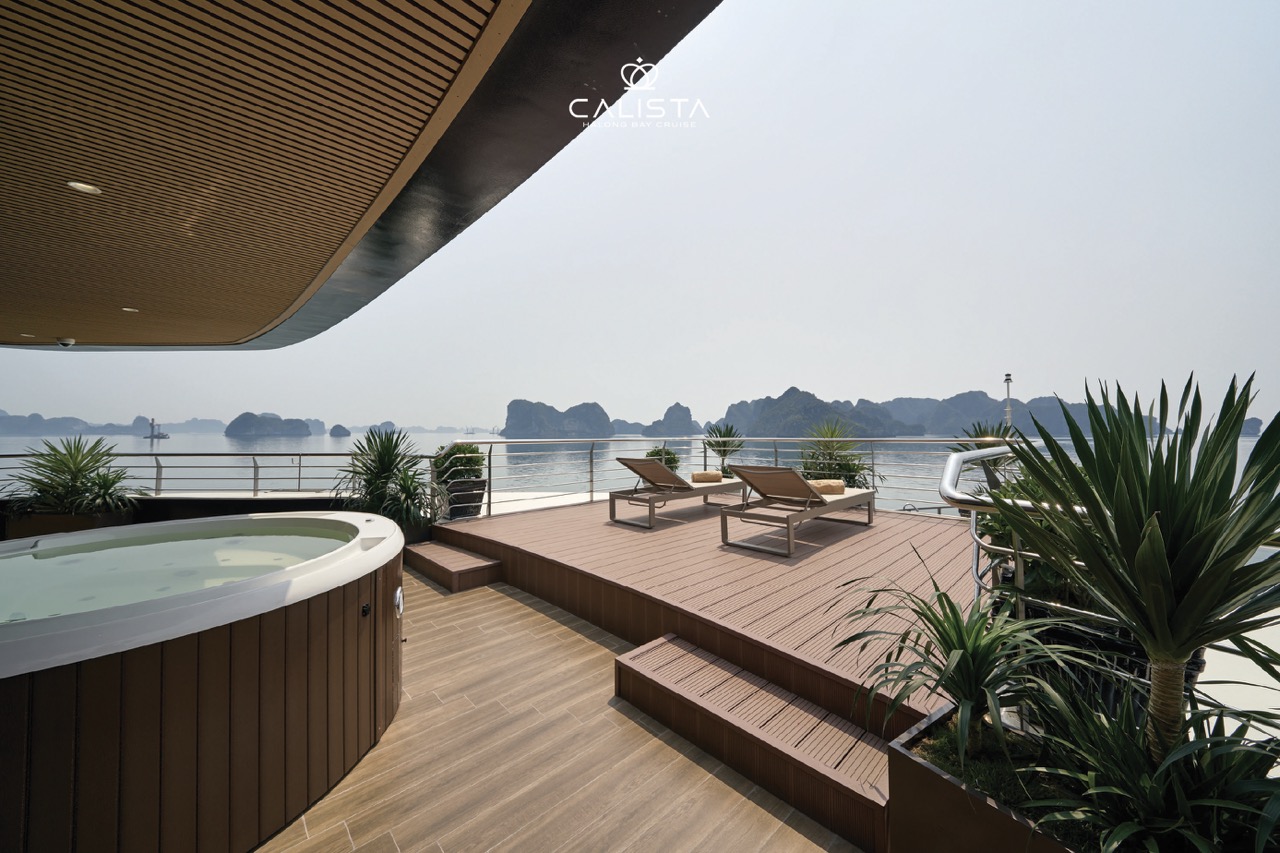 Relaxing view of Halong Bay from a cruise balcony with lounge chairs and lush plants, perfect for a.