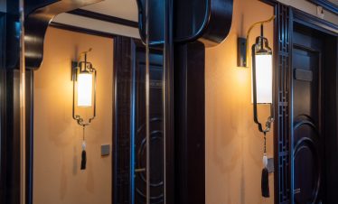 Interior lighting on Bai Tu Long cruise with traditional design and warm ambiance.