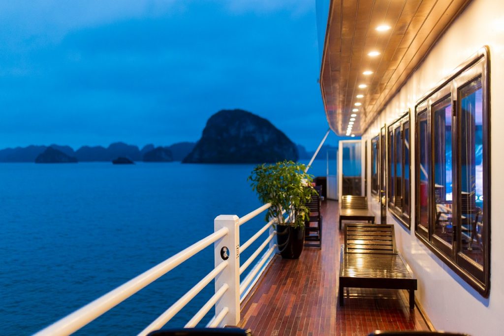 Stunning Halong Bay cruise balcony scene showcasing limestone islands and tranquil waters, perfect f.