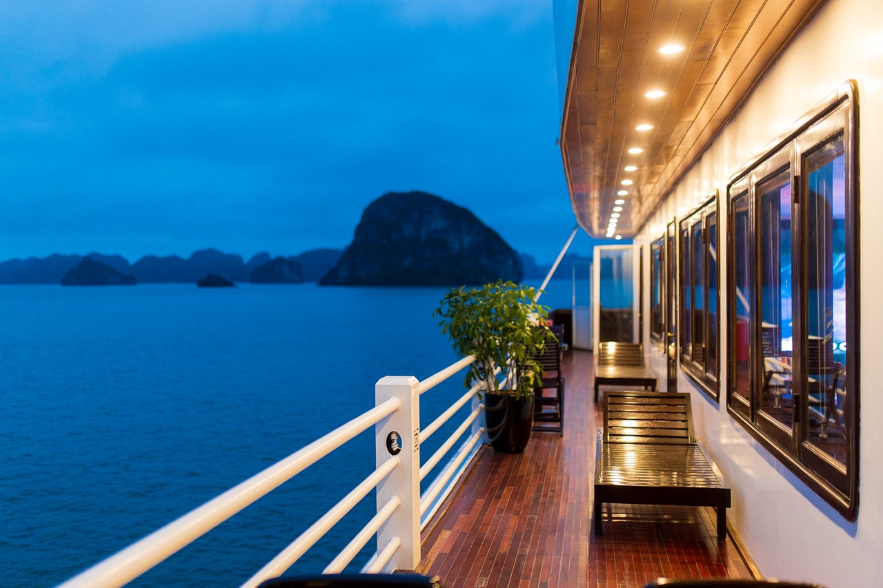 Stunning Halong Bay cruise balcony scene showcasing limestone islands and tranquil waters, perfect f.