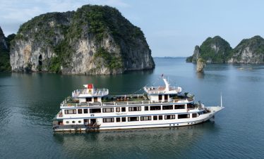 Elegant cruise sailing through stunning Halong Bay limestone karsts and emerald waters.