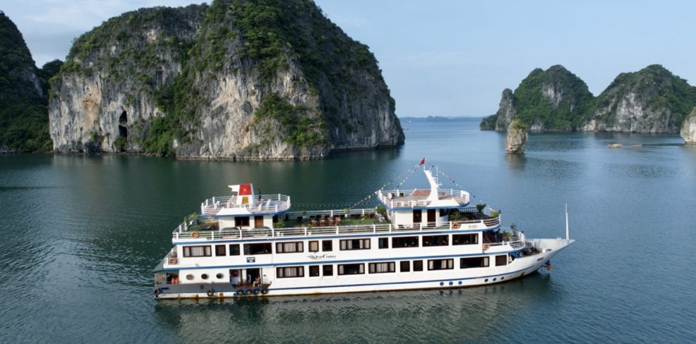 Elegant cruise sailing through stunning Halong Bay limestone karsts and emerald waters.