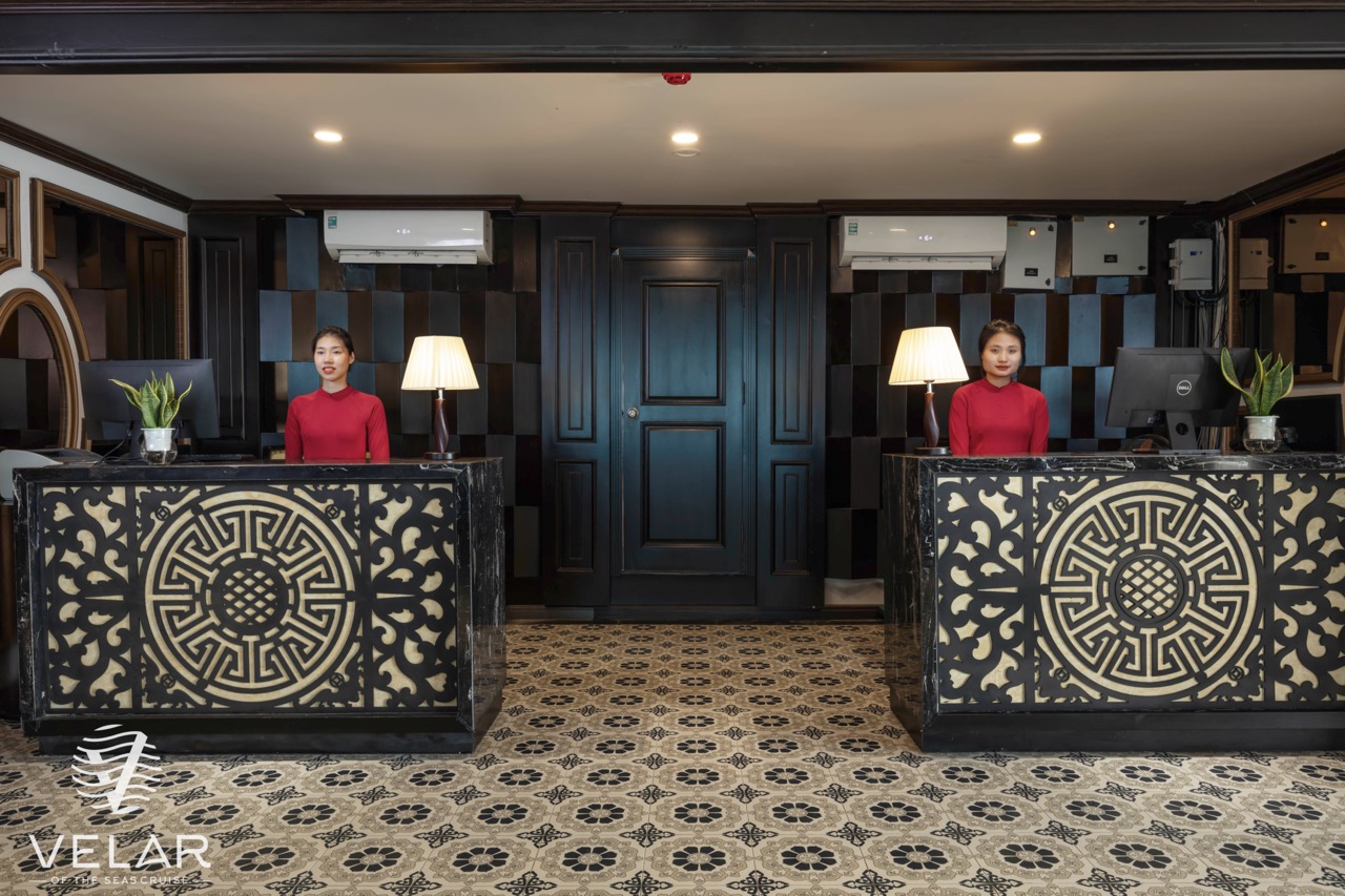 Reception area with elegant decor and friendly staff on Velar of The Sea Cruise in Halong Bay.