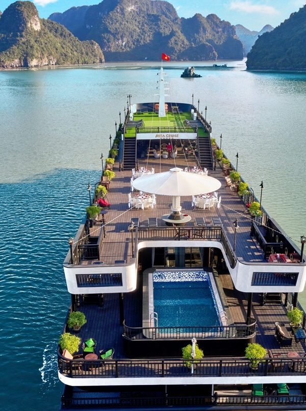 Stunning Halong Bay cruise ship with scenic limestone islands and calm waters.