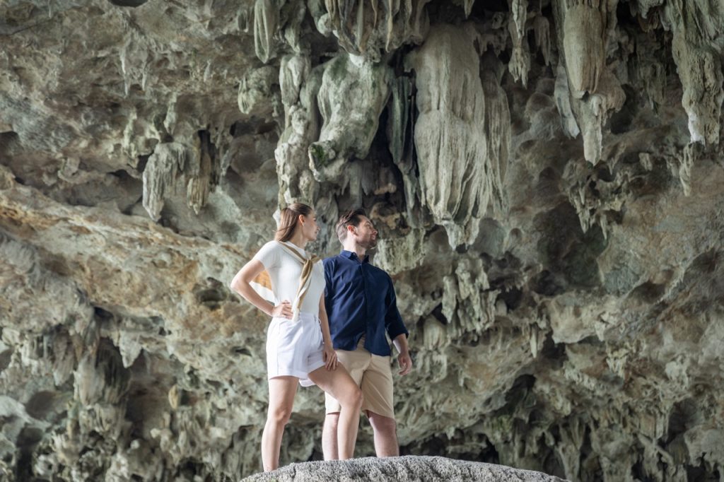 Stunning cave exploration in Halong Bay with travelers admiring the natural rock formations.