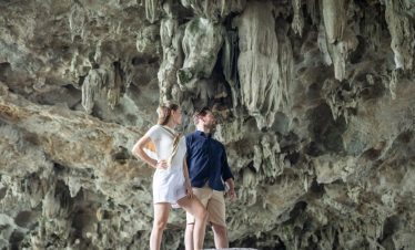 Stunning cave exploration in Halong Bay with travelers admiring the natural rock formations.