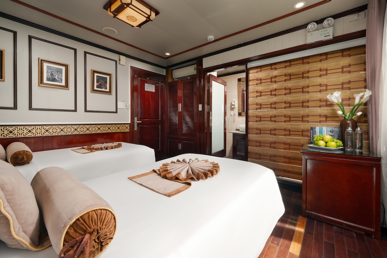 A cozy, elegant cruise cabin with traditional decor, perfect for a relaxing stay on Halong Bay.