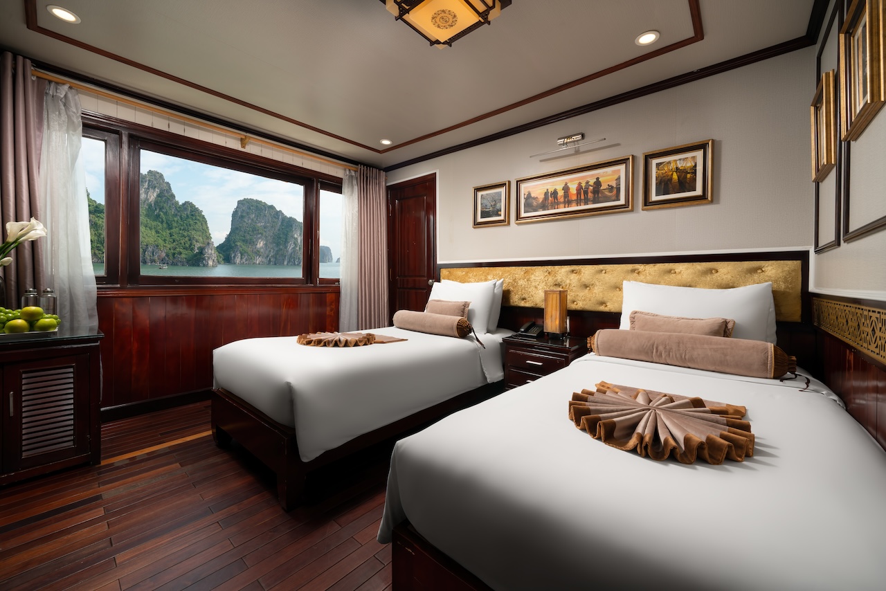Stunning view from a Halong Bay cruise balcony showcasing serene waters and lush karst formations.