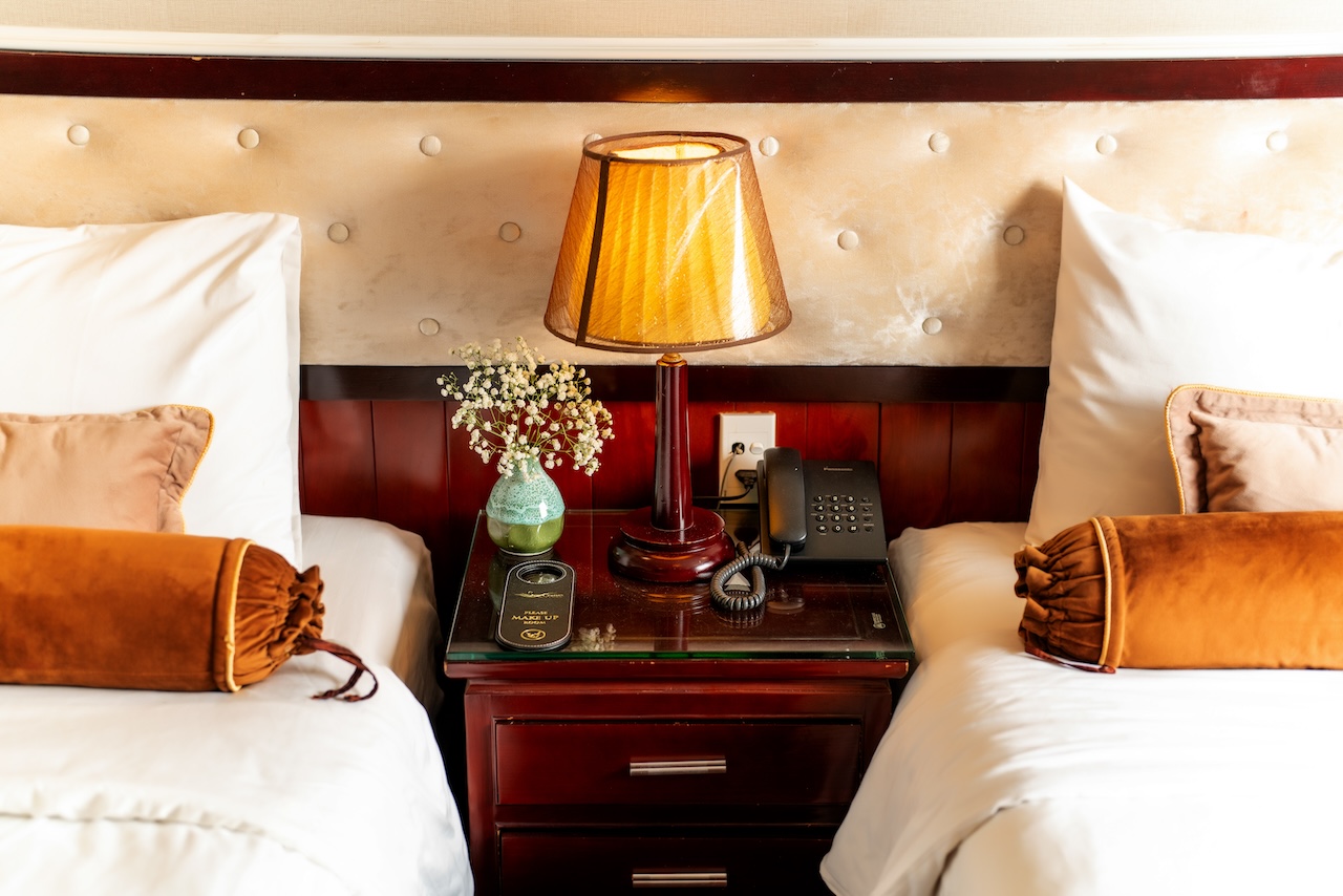 Elegant cruise balcony view in Halong Bay, showcasing serene waters and luxurious accommodations.