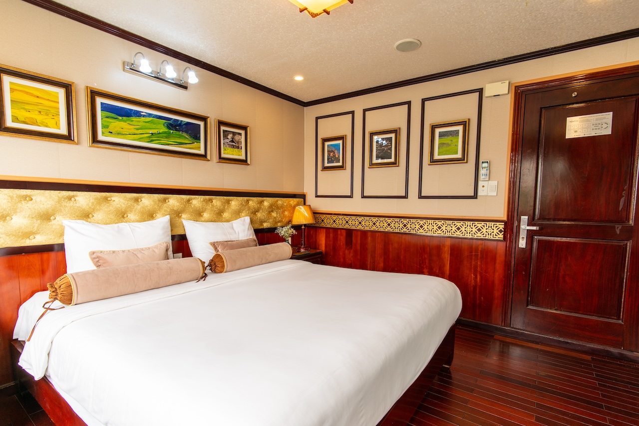 Comfortable cruise cabin with elegant decor and cozy ambiance in Halong Bay.