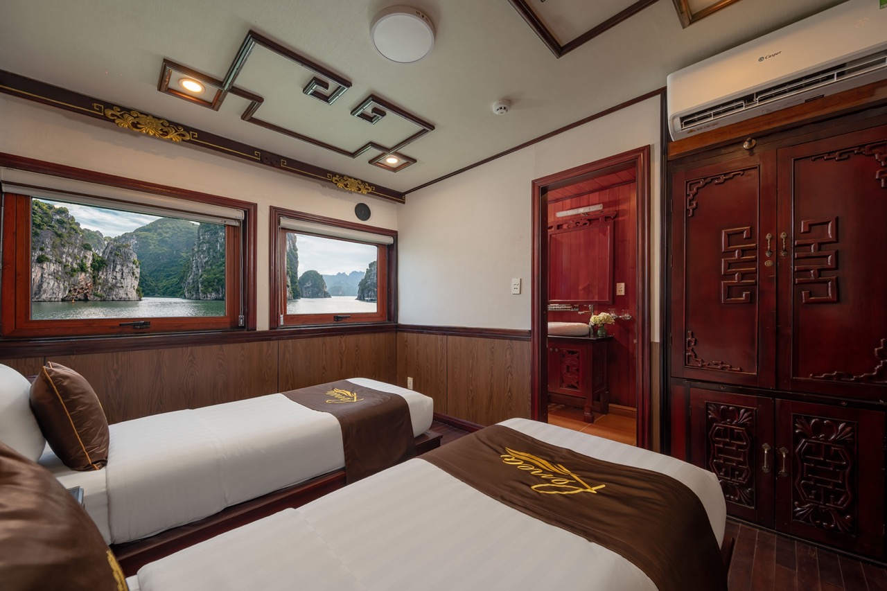 Beautiful cruise balcony view of Halong Bay with stunning limestone karsts and tranquil waters, perf.