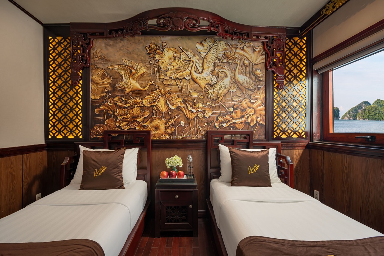 Luxurious cruise room featuring traditional Vietnamese design and comfortable beds, perfect for a re.