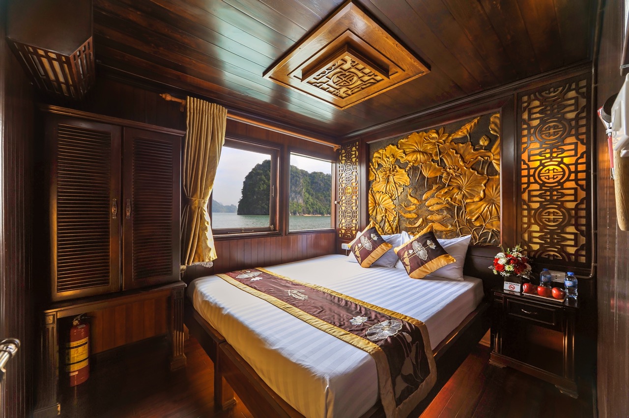 Elegant cruise balcony view of Bai Tu Long Bay with lush islands and calm waters, perfect for a rela.