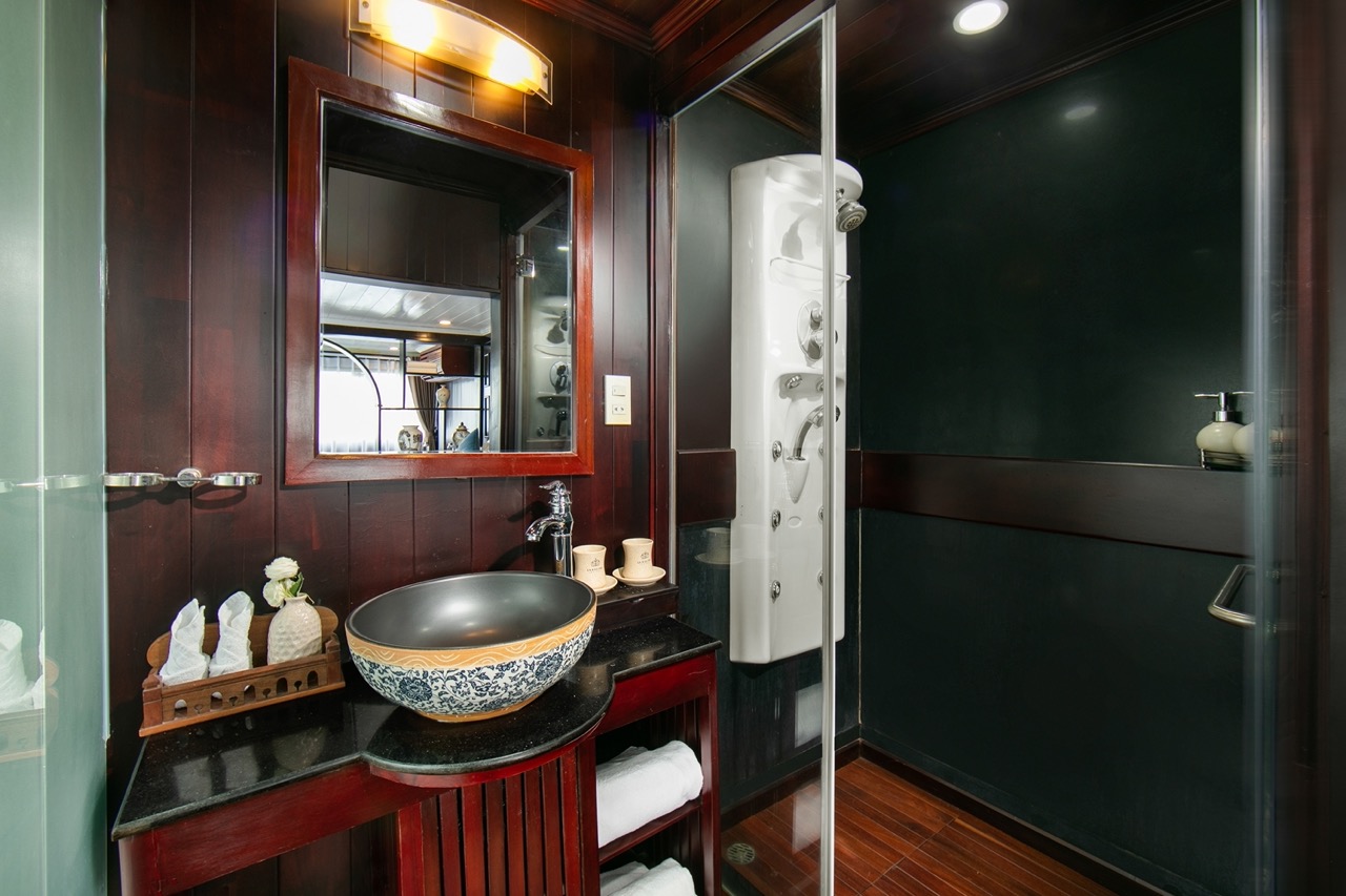 Elegant cruise bathroom with modern amenities and stylish decor, perfect for a relaxing Halong Bay e.