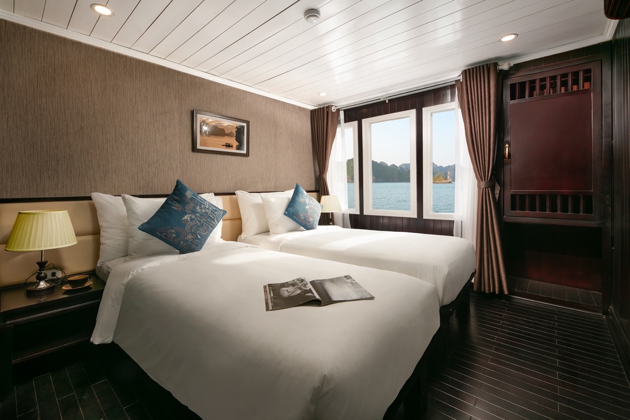 Luxurious cruise balcony view of Halong Bay with serene waters and scenic islands, perfect for a rel.