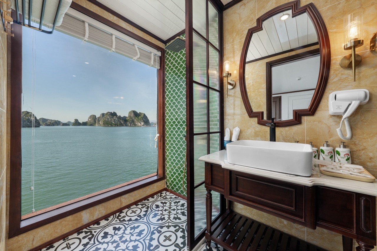 Stunning view of Bai Tu Long Bay from the cruise balcony, showcasing tranquil waters and limestone i.