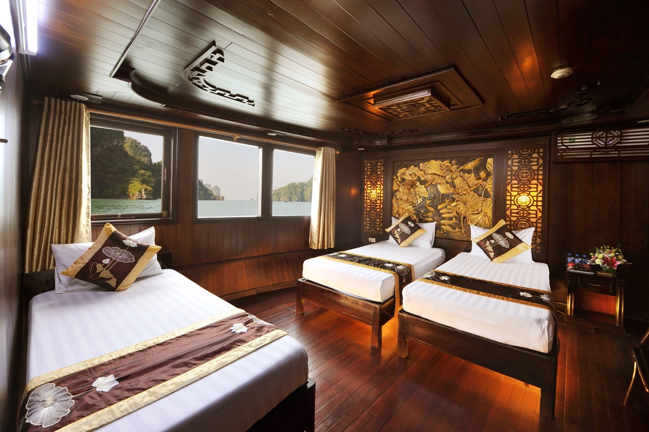 Elegant cruise cabin with panoramic views of Bai Tu Long Bay, perfect for a relaxing getaway.