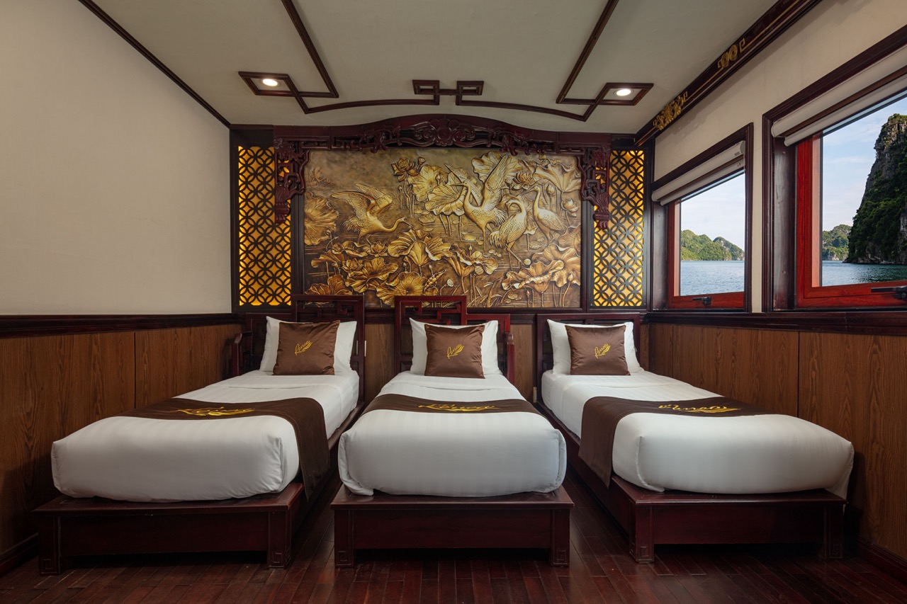 Elegant cruise cabin with traditional decor and scenic bay views in Halong Bay.