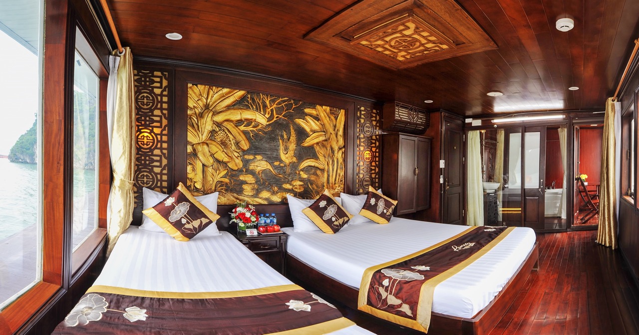 Elegant cruise balcony with plush beds and traditional decor in Bai Tu Long Bay.