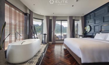 Elegant cruise balcony view of Halong Bay with spacious room and modern amenities.