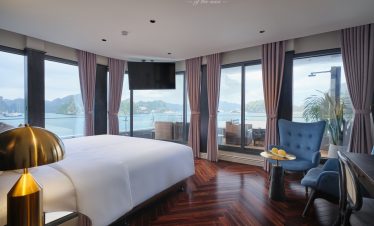 Panoramic view of Halong Bay from a luxurious cruise balcony suite, perfect for a memorable travel e.