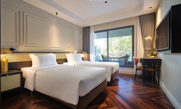 Halong Bay cruise balcony with elegant interior and scenic view.