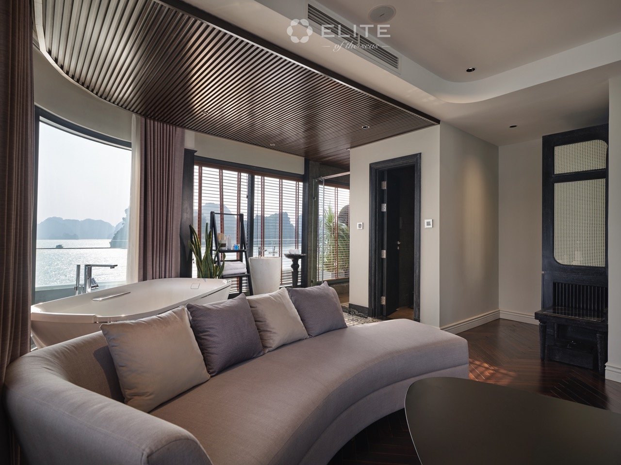 Elegant cruise balcony view of Halong Bay with modern interior design.