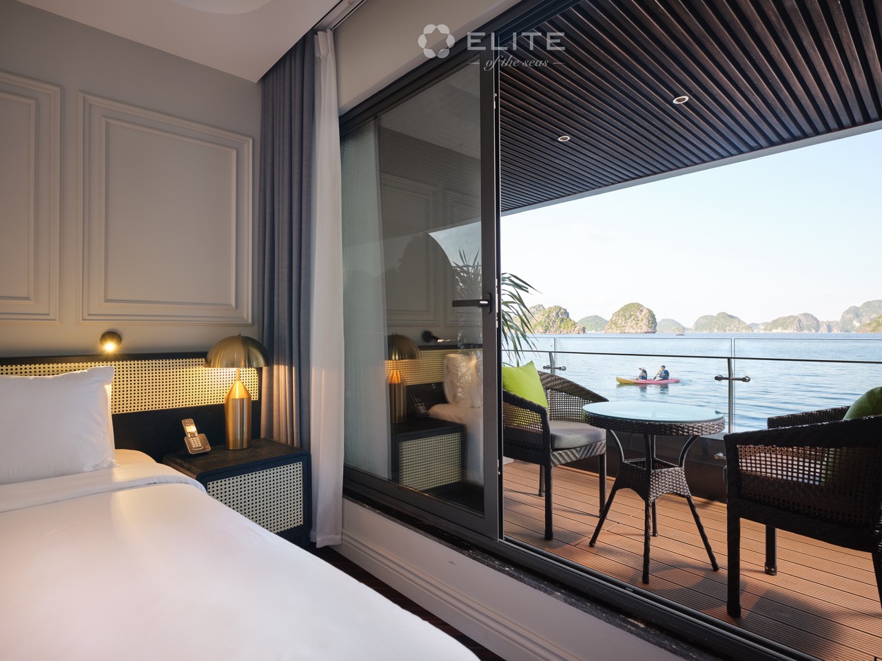 Stunning view from a cruise balcony in Halong Bay, featuring calm waters and limestone islands, perf.