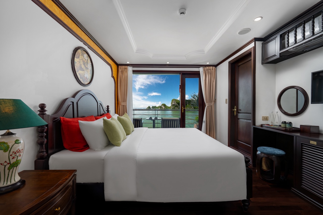 Scenic view from cruise balcony overlooking Bai Tu Long Bay with lush islands and calm waters.