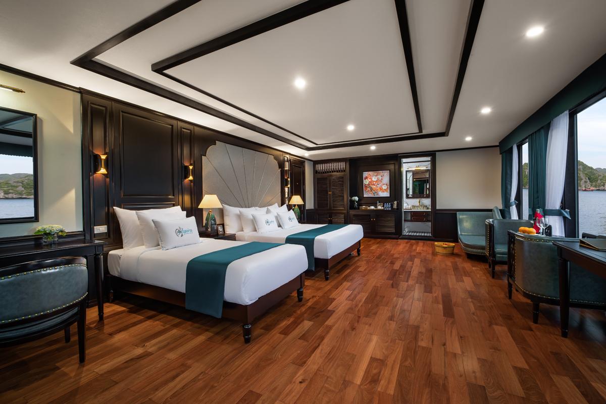Luxurious hotel room with modern decor, river view, twin beds, and elegant furnishings for a premium stay.
