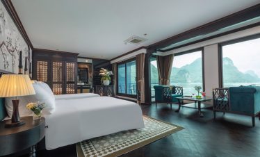 Luxurious cruise balcony view of Halong Bay with stunning karst formations and tranquil waters.
