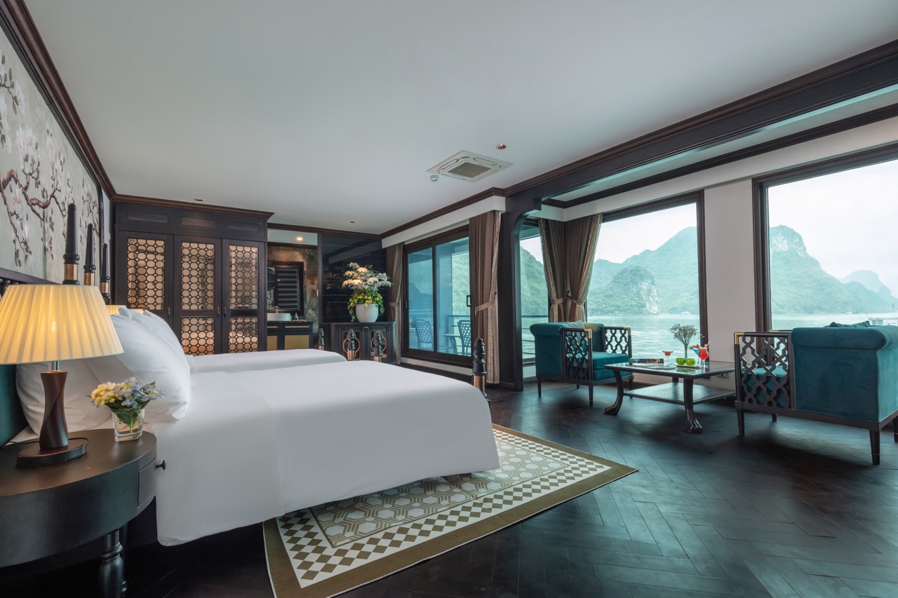 Luxurious cruise balcony view of Halong Bay with stunning karst formations and tranquil waters.
