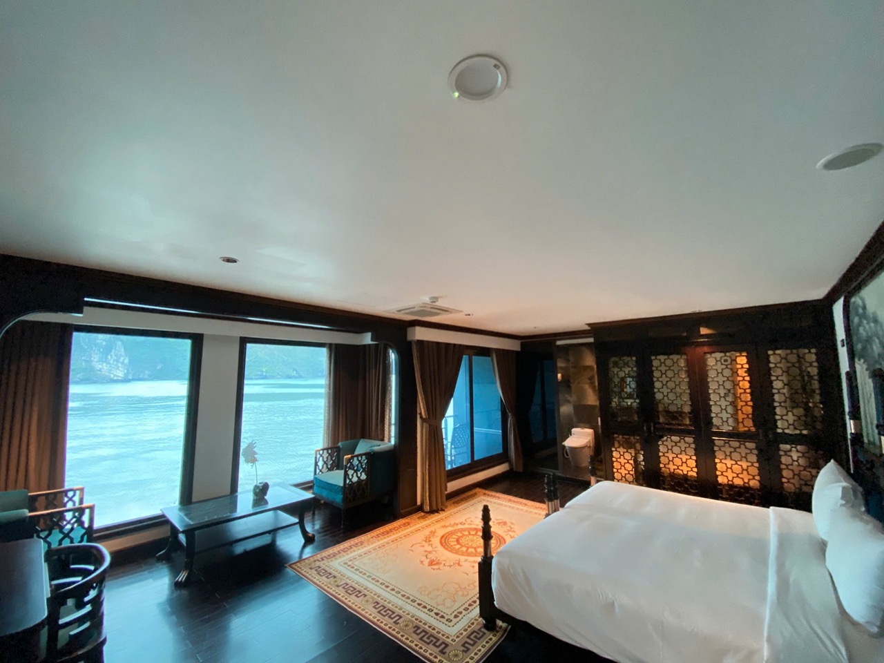 Stunning cruise balcony view in Halong Bay with luxurious interior and serene waters.