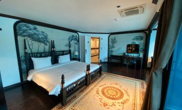 Halong Bay cruise balcony with scenic views, elegant interior, and tranquil atmosphere.