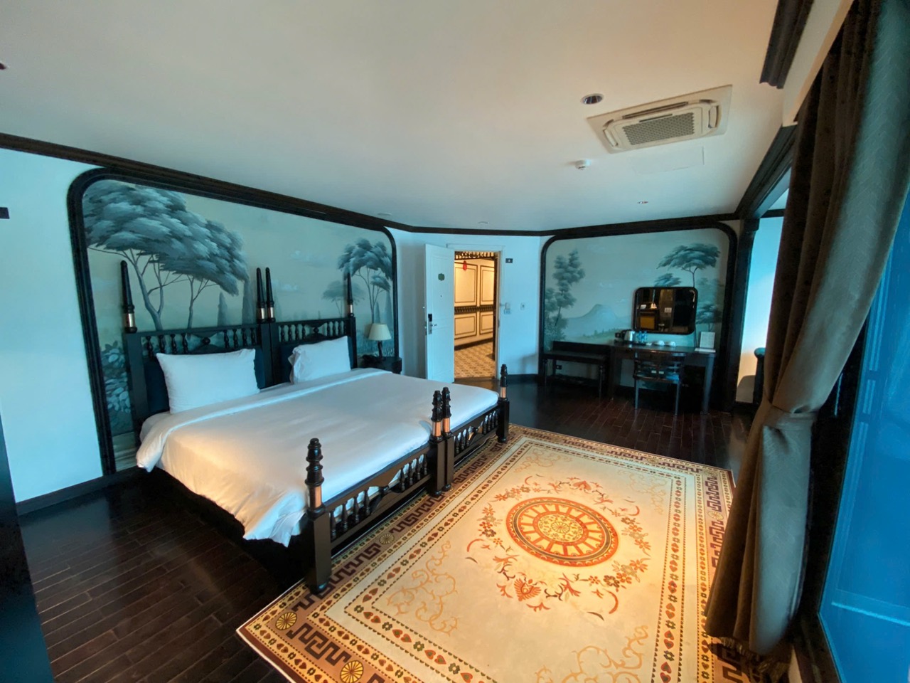 Halong Bay cruise balcony with scenic views, elegant interior, and tranquil atmosphere.