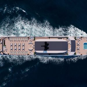 Luxury cruise yacht with outdoor sunbathing deck and swimming pool in the open sea.