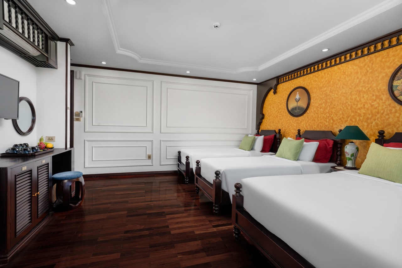 Luxurious cruise cabin with elegant decor and comfortable beds in Bai Tu Long Bay.