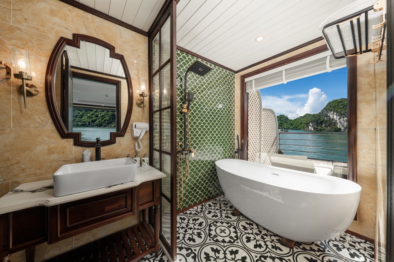 Bai Tu Long Bay cruise balcony with stunning ocean views and luxurious bathroom ambiance.