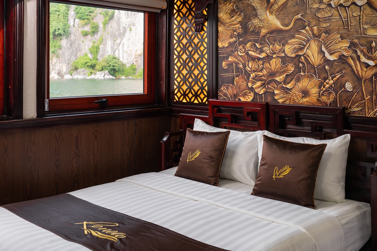 Stunning view from the cruise balcony overlooking Halong Bay's emerald waters and limestone karsts.