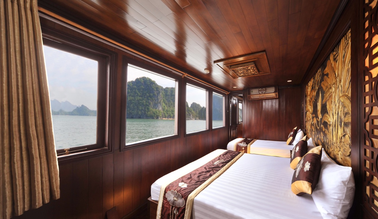 Elegant cruise cabin with panoramic views of Bai Tu Long Bay, perfect for a relaxing and luxurious g.