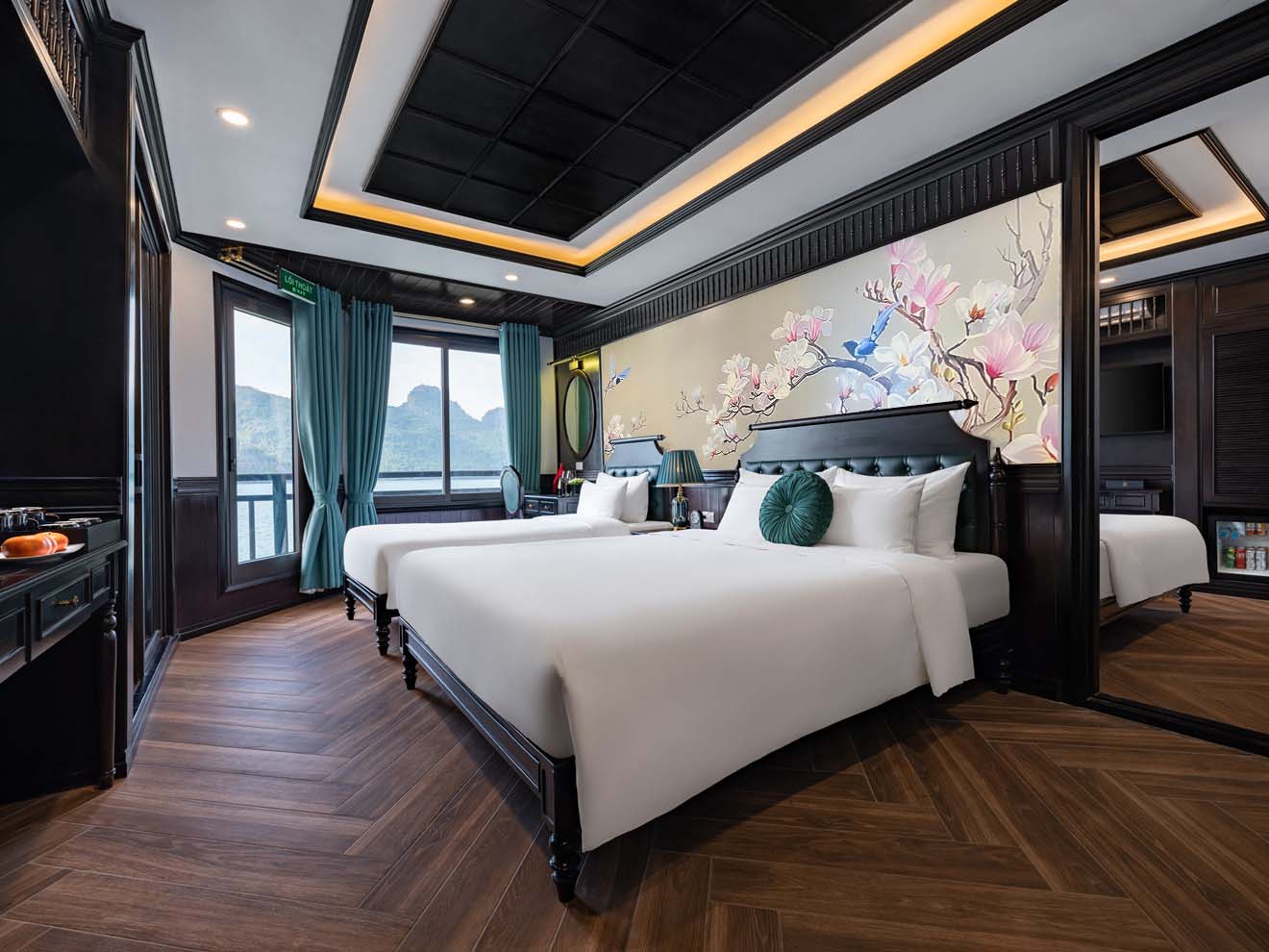 Elegant cruise balcony view of Halong Bay with scenic mountains and calm waters.