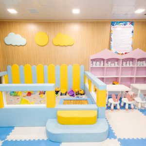 Colorful indoor children's play area with toys, soft flooring, and playful decor for kids' fun.