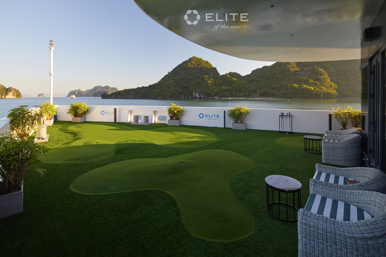 Stunning view of Halong Bay from cruise balcony with lush green islands and calm waters.