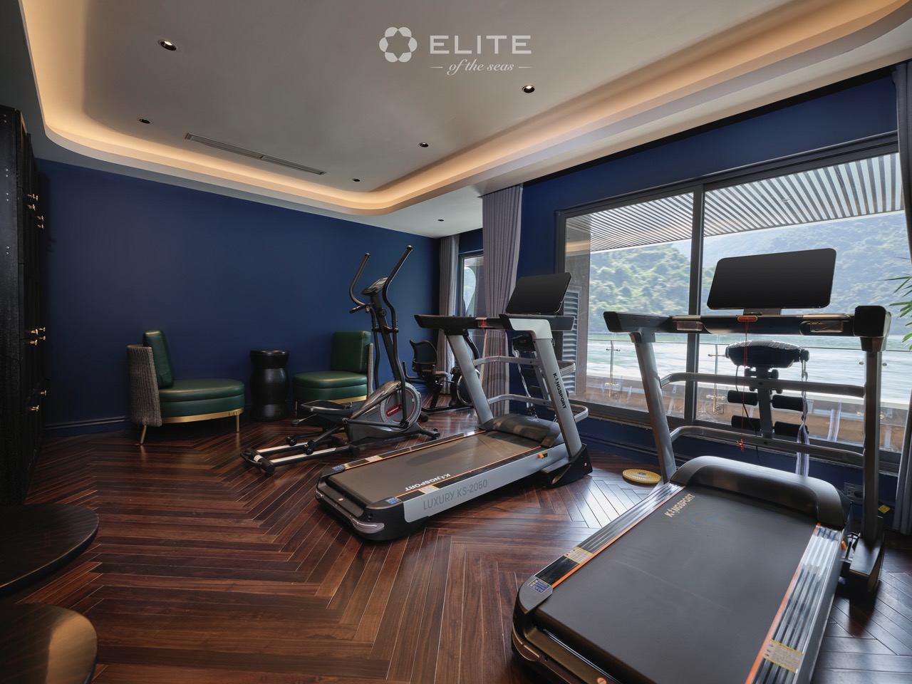 Relaxing gym with scenic bay view on Halong Bay cruise ship.