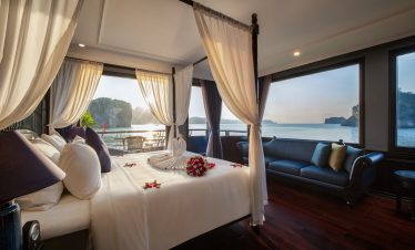 Elegant cruise balcony view of Halong Bay with serene waters and limestone islands. Perfect for a ro.